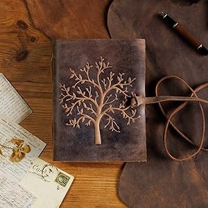 Close up of embossed tree on leather notebook